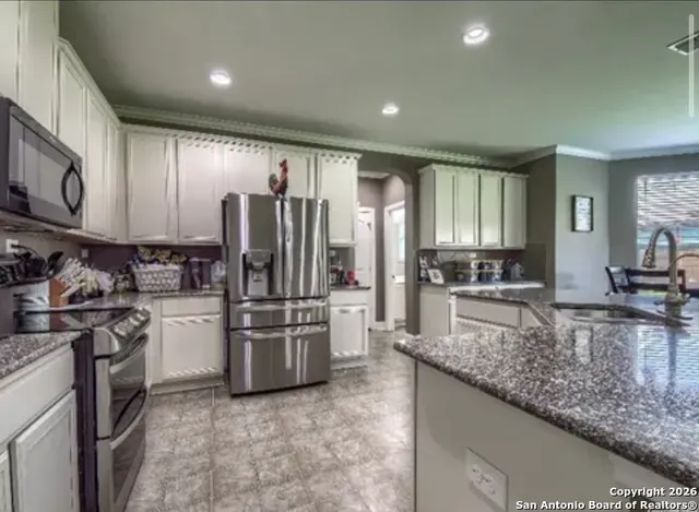 a kitchen with refrigerator cabinets and stainless steel appliances