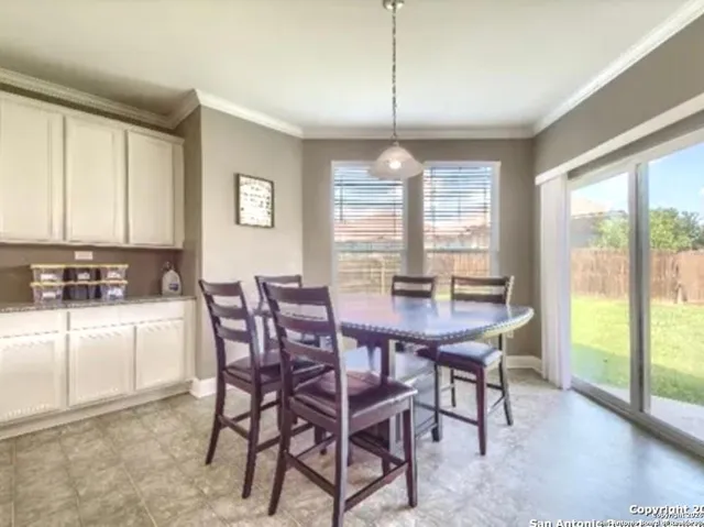 a view of a dining room with furniture window and outside view