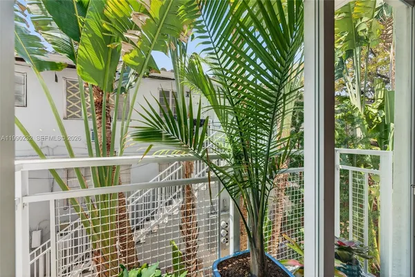 a dining room with furniture and flowers