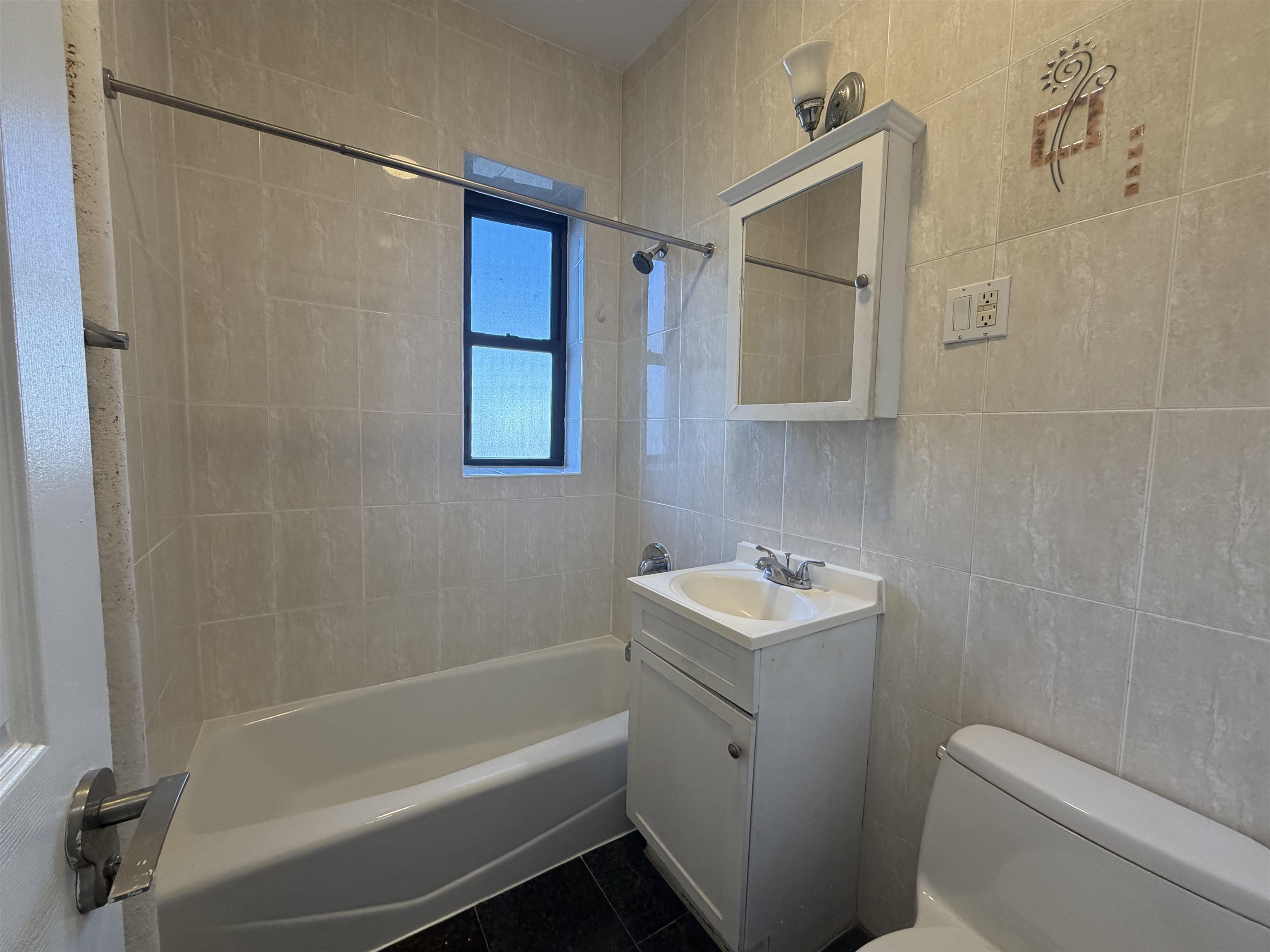 57 Corbin Avenue, Unit 4 Jersey City, NJ 07306 - Photo 7 of 8 a bathroom with a sink toilet and shower