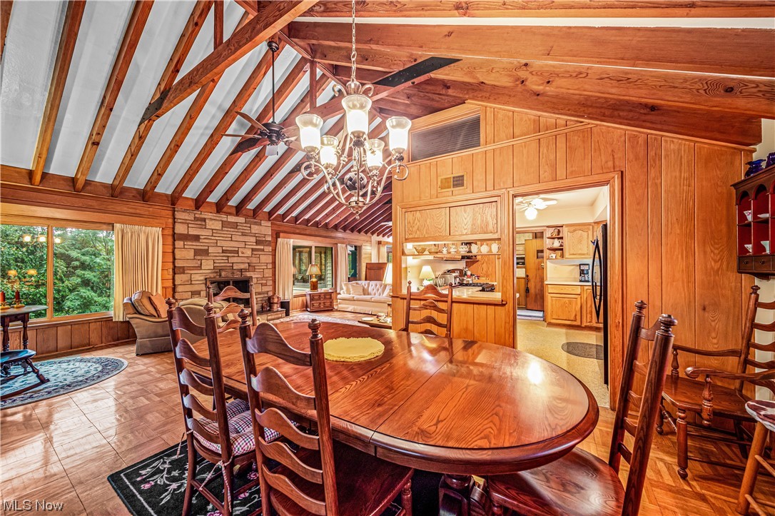 35510 Ridge Road Willoughby, OH 44094 - Photo 7 of 35 Dining space with a fireplace, a chandelier, vaulted ceiling with beams, and a high ceiling