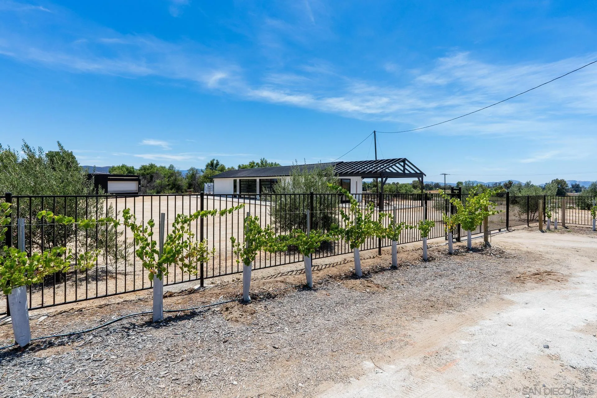 36051 East Benton Road, Unit 1 Temecula, CA 92592 - Photo 33 of 42 a view of a pathway with a wrought fence