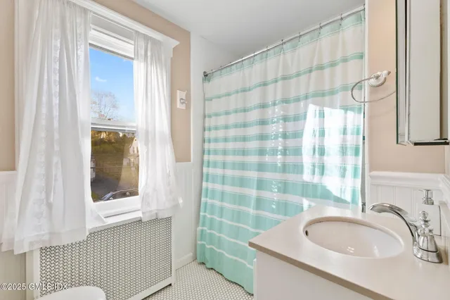 a bathroom with a sink a mirror and a shower