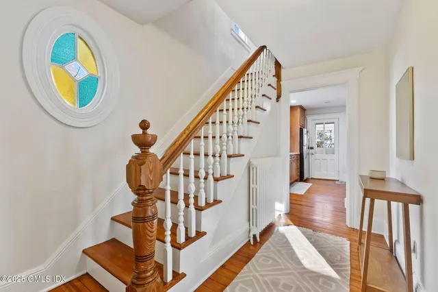 a view of entryway livingroom and hall with wooden floor