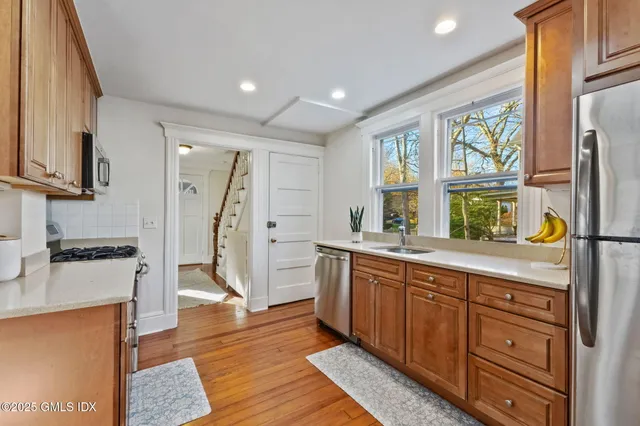 a kitchen with stainless steel appliances granite countertop a refrigerator and a stove top oven