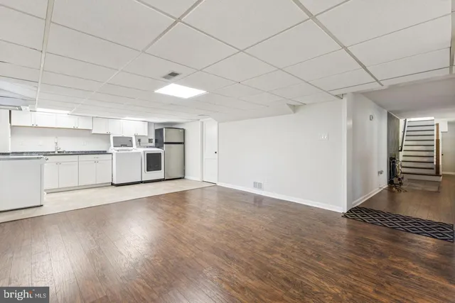 a view of a kitchen with wooden floor and electronic appliances