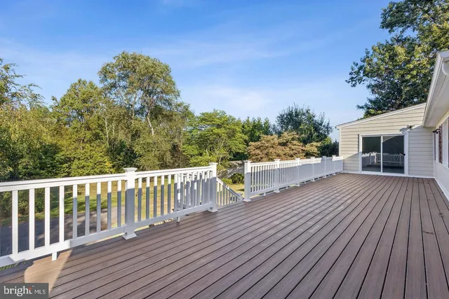 a view of a house with a wooden deck