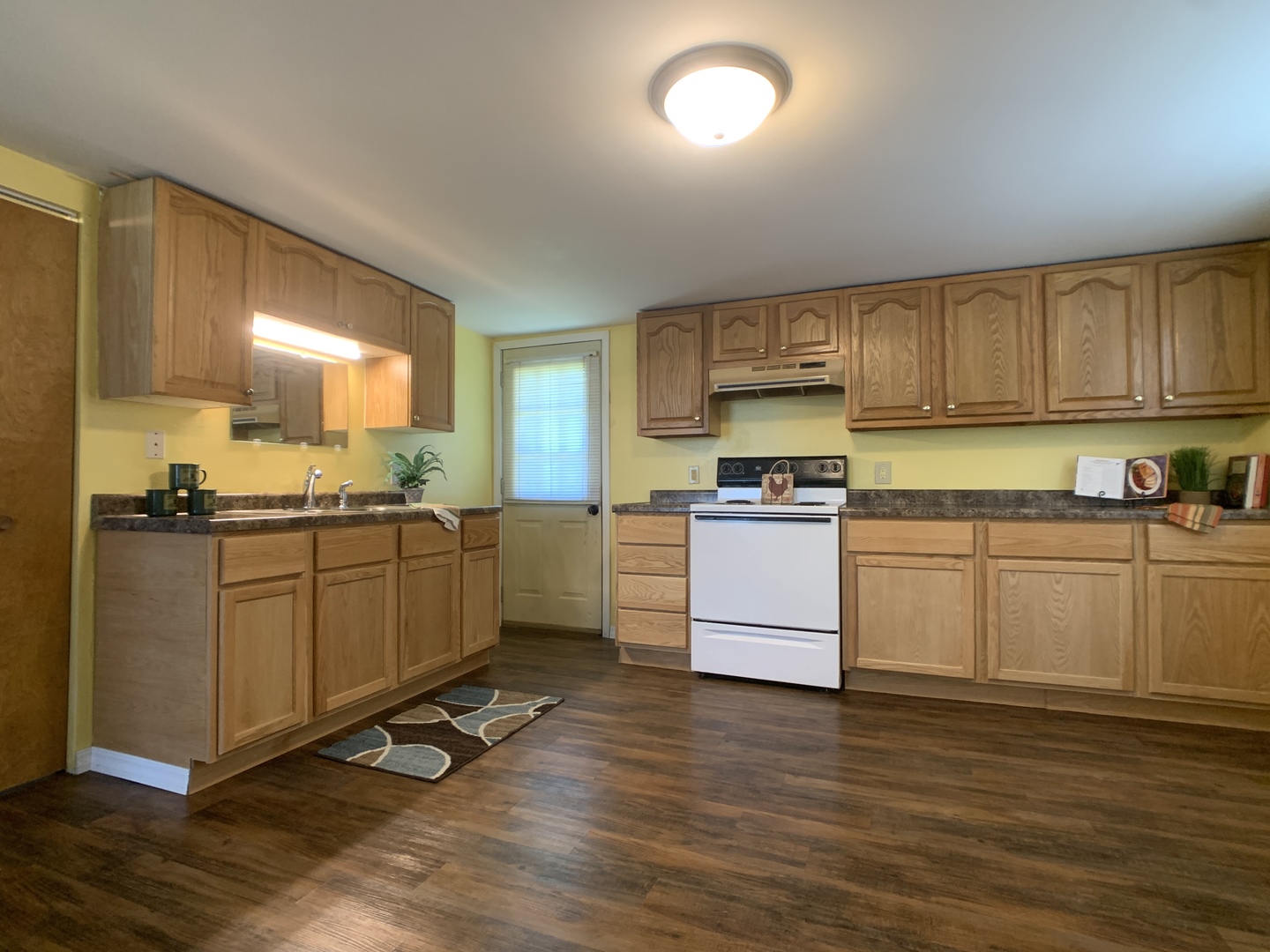 205 West 7th Street Spring Valley, IL 61362 - Photo 15 of 34 a kitchen with granite countertop white cabinets and white appliances