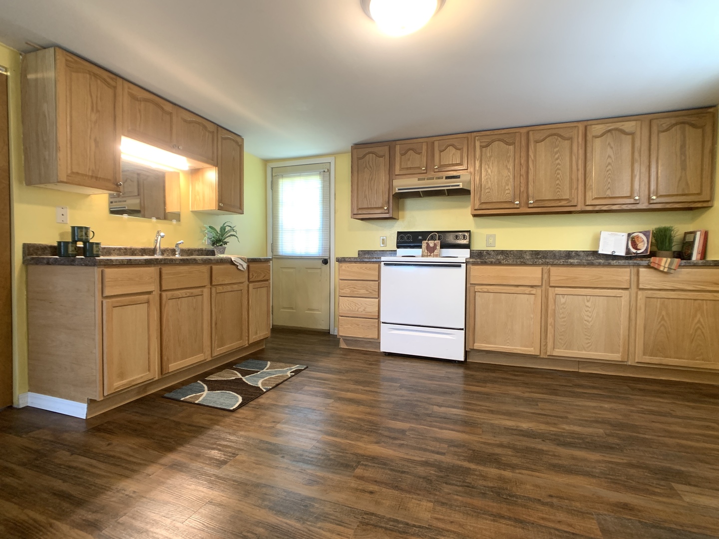 205 West 7th Street Spring Valley, IL 61362 - Photo 16 of 34 a kitchen with a sink wooden floor and window