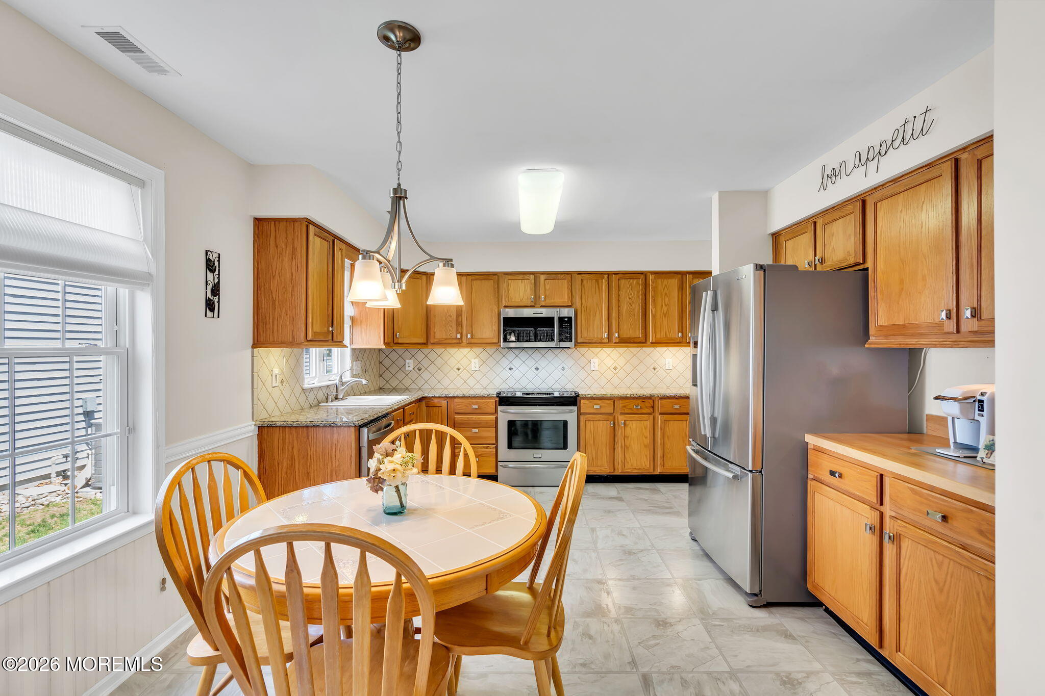 10 Congressional Road Jackson, NJ 08527 - Photo 21 of 72 a kitchen with stainless steel appliances granite countertop a kitchen island a stove a table and chairs