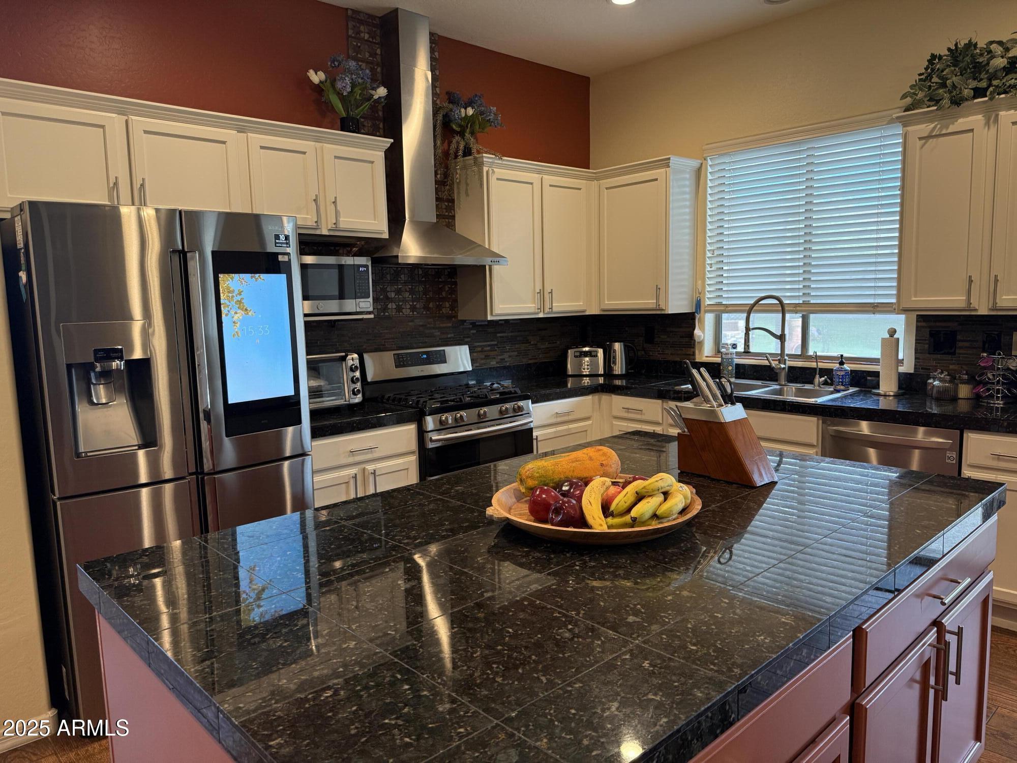 2245 West Clearview Trail Phoenix, AZ 85086 - Photo 16 of 76 a kitchen with stainless steel appliances granite countertop a refrigerator a stove and a sink