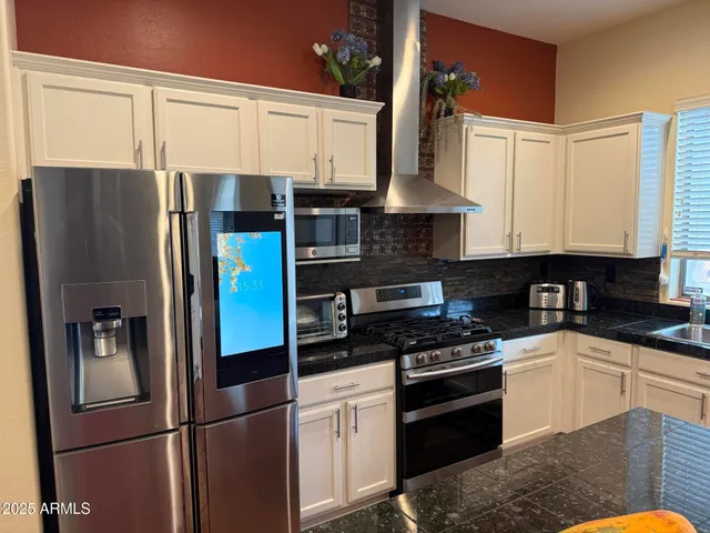 a living room with furniture a fireplace and a dining table with wooden floor