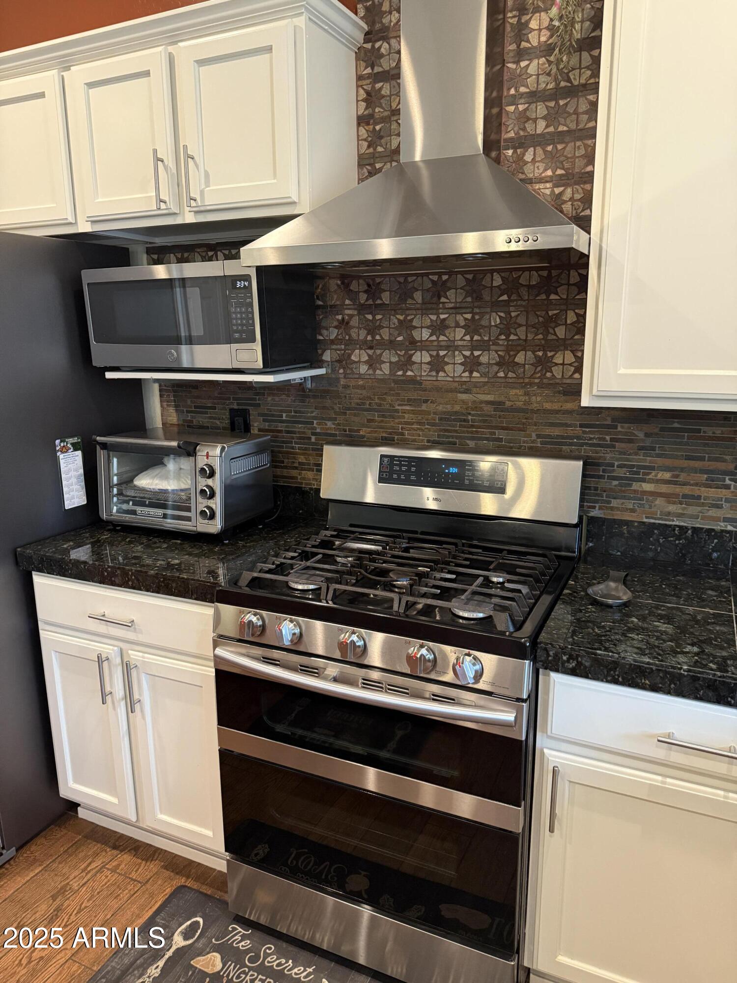 2245 West Clearview Trail Phoenix, AZ 85086 - Photo 19 of 76 a stove top oven sitting inside of a kitchen