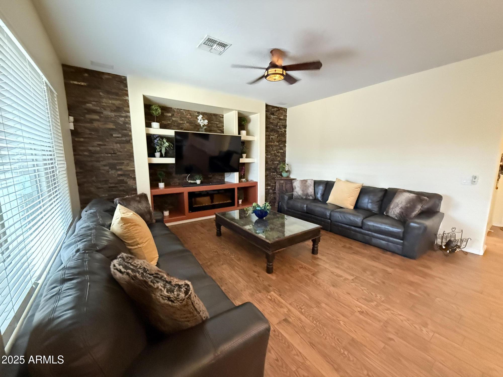 2245 West Clearview Trail Phoenix, AZ 85086 - Photo 22 of 76 a living room with furniture and a flat screen tv