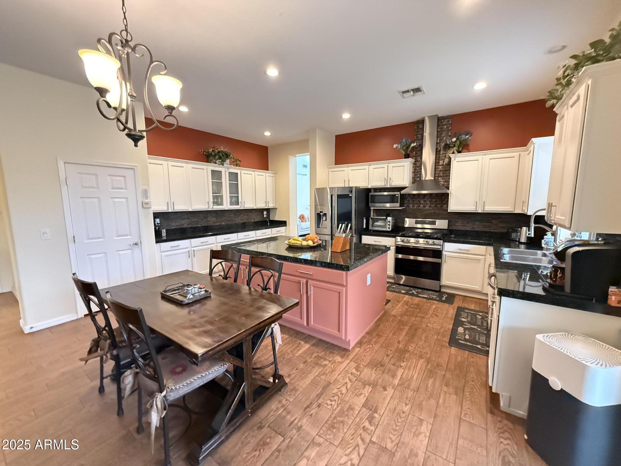 2245 West Clearview Trail Phoenix, AZ 85086 - Photo 23 of 76 a kitchen with a table chairs stove and refrigerator