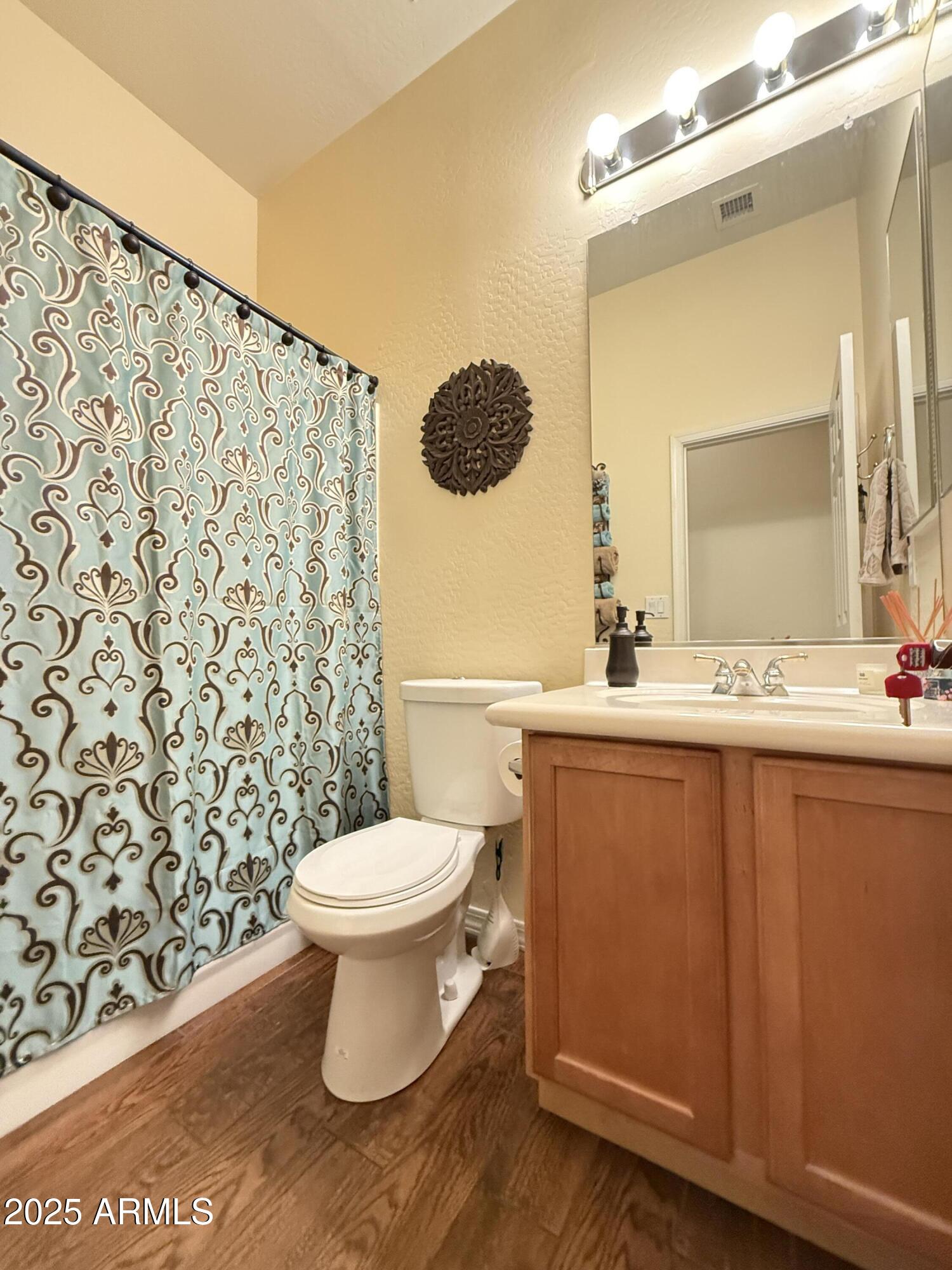 2245 West Clearview Trail Phoenix, AZ 85086 - Photo 28 of 76 a bathroom with a toilet a sink and a mirror