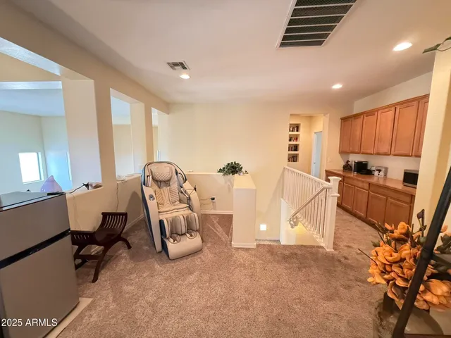 a spacious bedroom with a bed and a chandelier