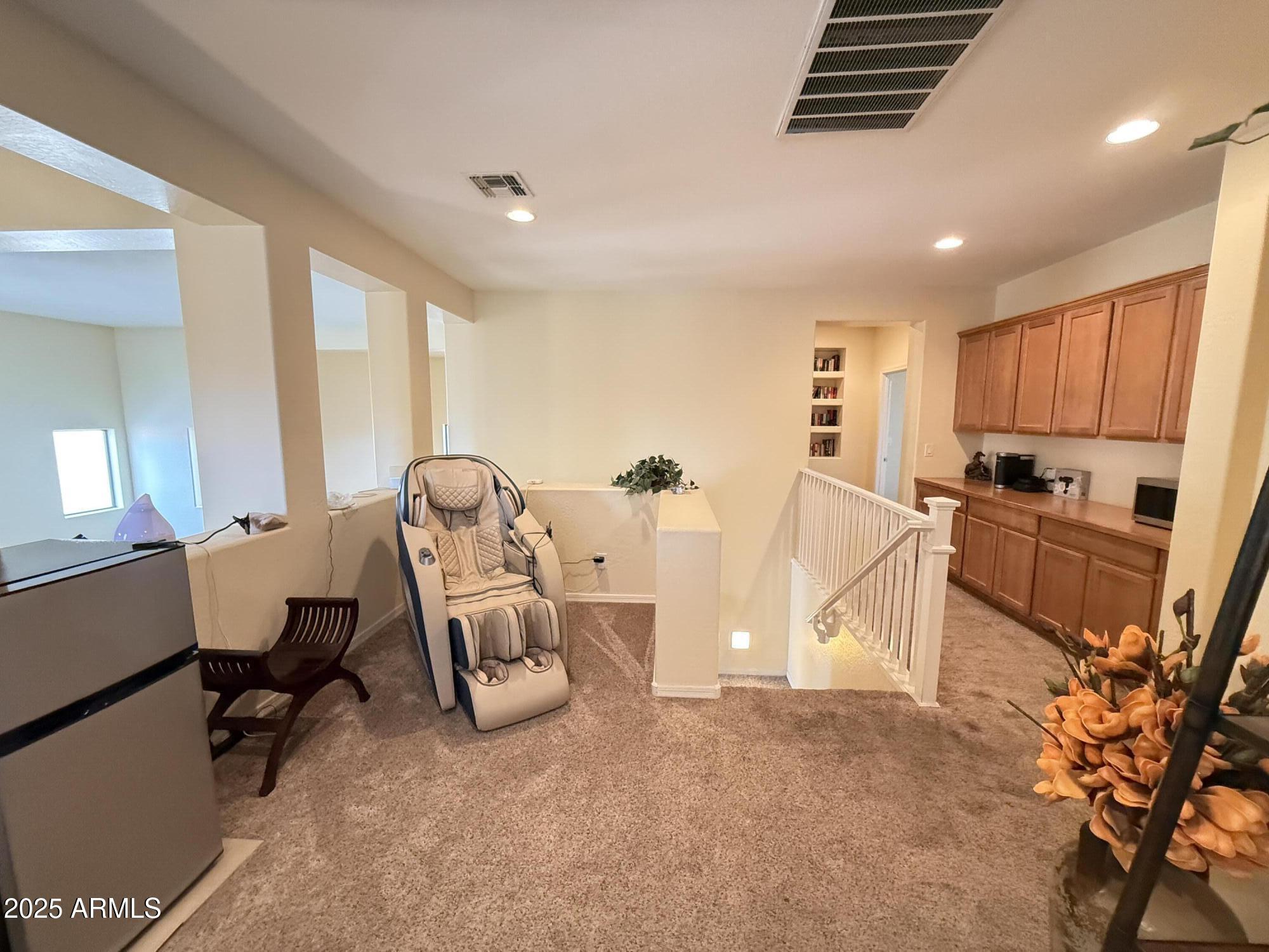 2245 West Clearview Trail Phoenix, AZ 85086 - Photo 33 of 76 a living room with furniture a flat screen tv and a refrigerator