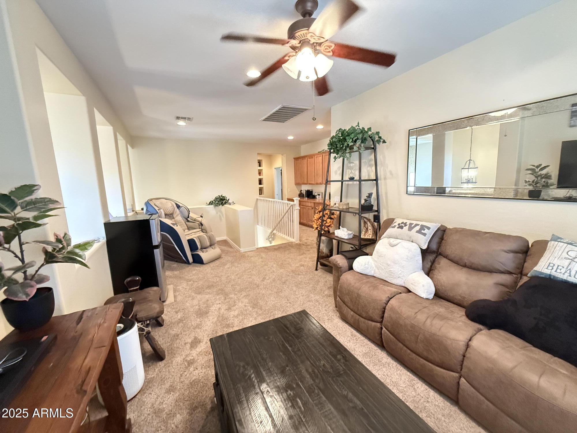 2245 West Clearview Trail Phoenix, AZ 85086 - Photo 35 of 76 a living room with furniture ceiling fan and a rug