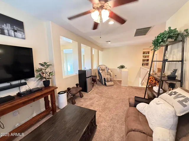 a bedroom with a bed and a ceiling fan