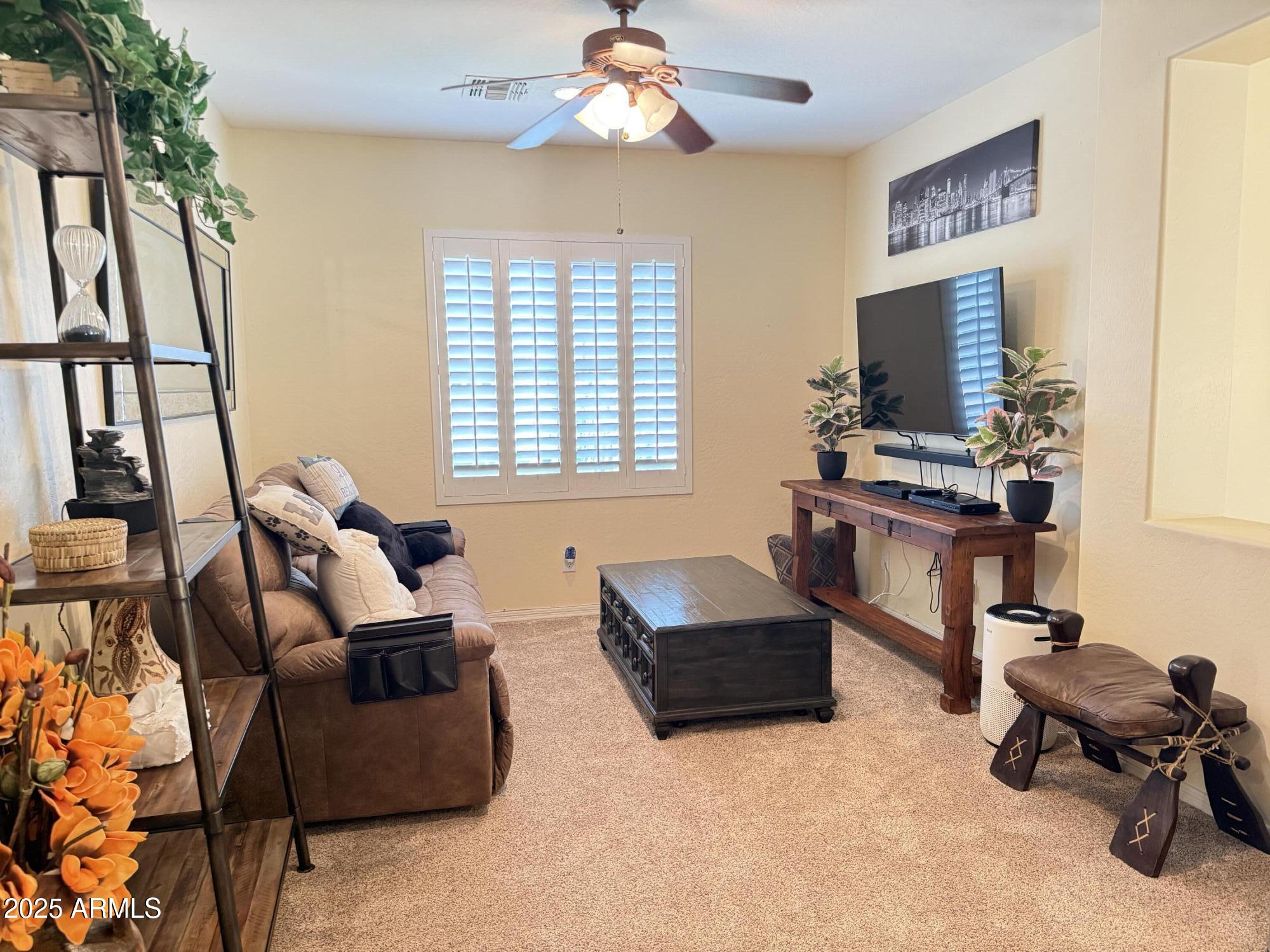 2245 West Clearview Trail Phoenix, AZ 85086 - Photo 37 of 76 a living room with furniture and a flat screen tv