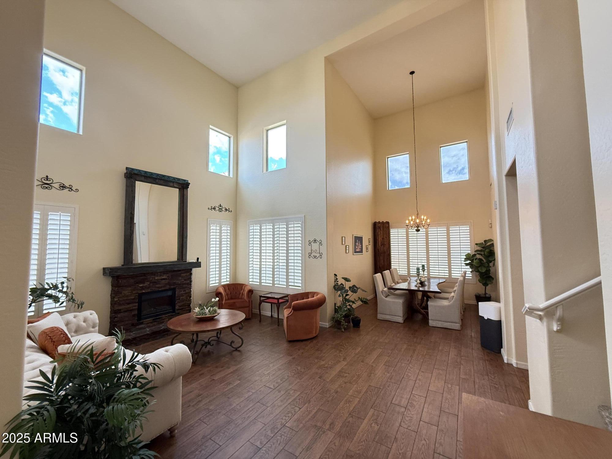 2245 West Clearview Trail Phoenix, AZ 85086 - Photo 4 of 76 a living room with furniture and a fireplace