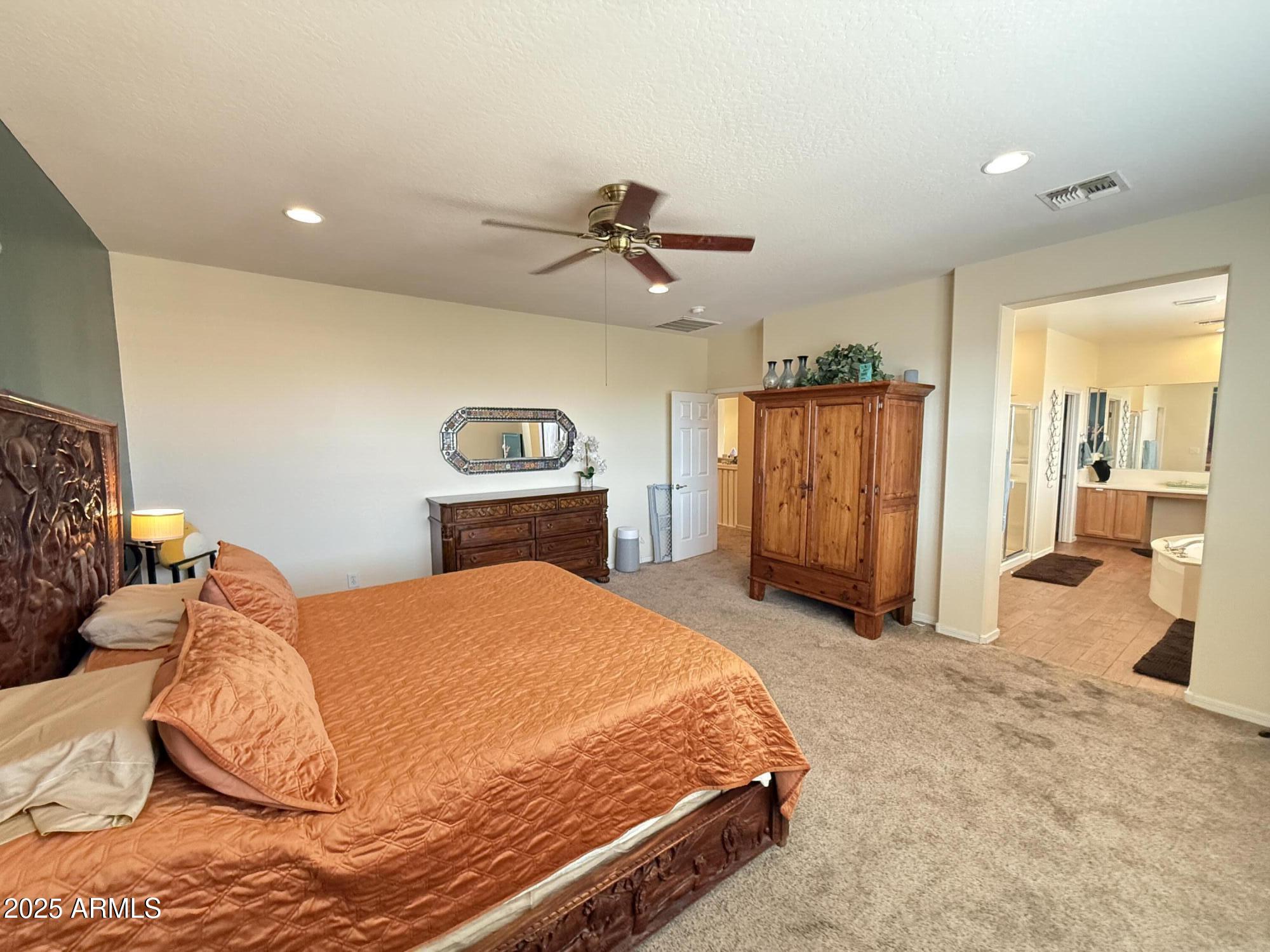 2245 West Clearview Trail Phoenix, AZ 85086 - Photo 42 of 76 a bedroom with a bed and a chandelier