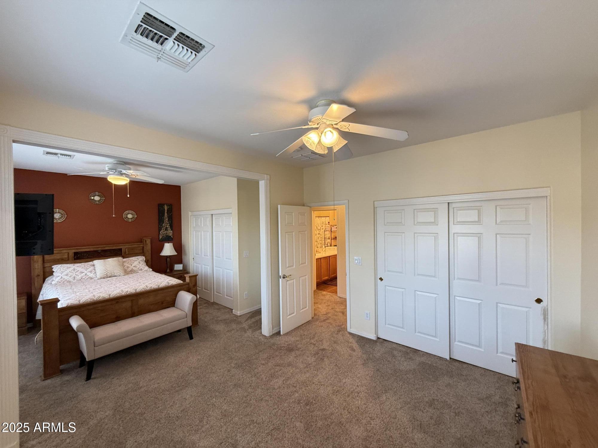 2245 West Clearview Trail Phoenix, AZ 85086 - Photo 50 of 76 a bedroom with a bed and a chandelier