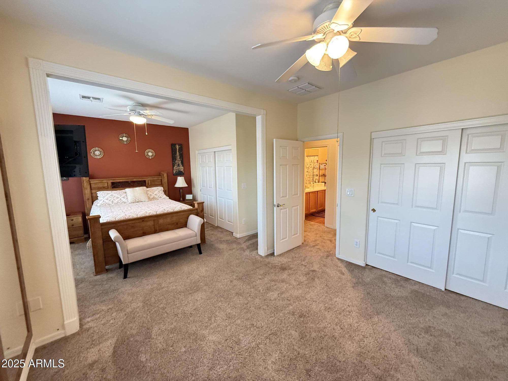 2245 West Clearview Trail Phoenix, AZ 85086 - Photo 52 of 76 a bedroom with a bed and a ceiling fan