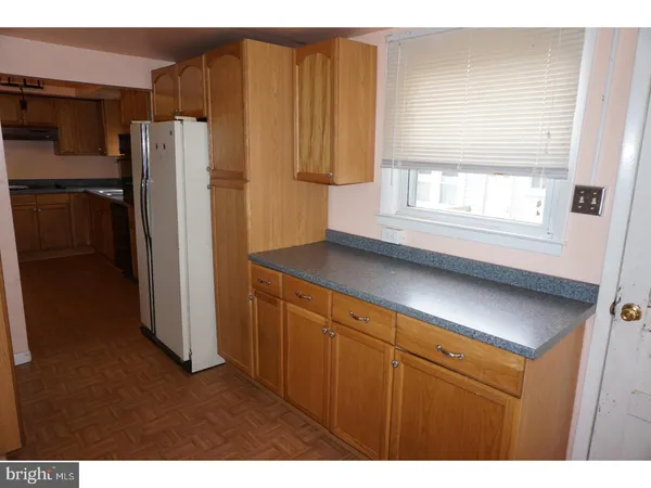 a kitchen with stainless steel appliances a refrigerator and a window