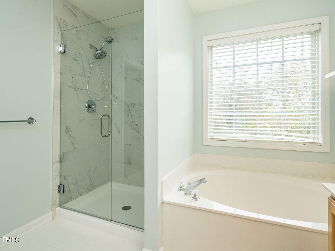 214 Competition Road Raleigh, NC 27603 - Photo 23 of 32 a bathroom with a bathtub and shower