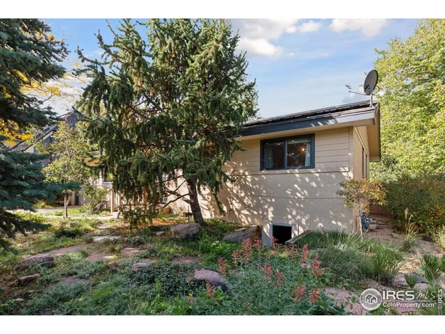 a view of house with backyard