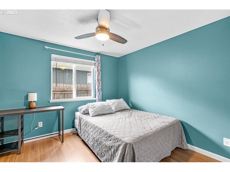 1528 Briar Road Independence, OR 97351 - Photo 17 of 25 a bedroom with a bed and a chandelier