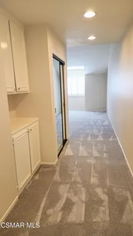 a view of a hallway to rooms