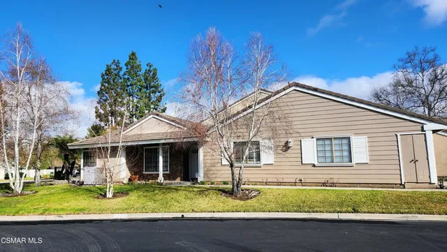 a front view of a house with a yard table and chairs
