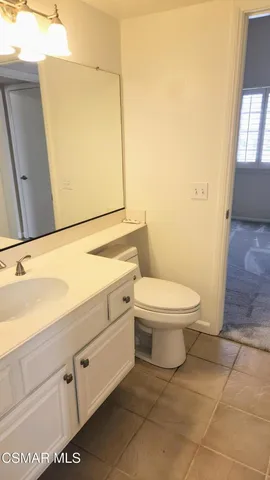 a bathroom with a sink a toilet and mirror
