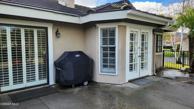 an outdoor space with furniture and umbrella