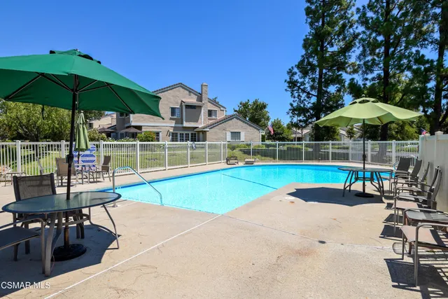 a backyard of a house with lots of green space and lake view