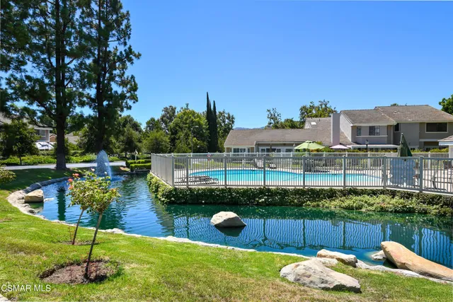 a view of a house with swimming pool yard and sitting area