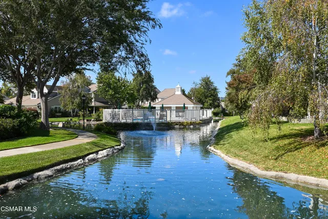 a view of a garden with a house in the background
