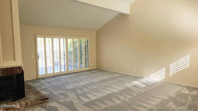 a view of an empty room with a fireplace