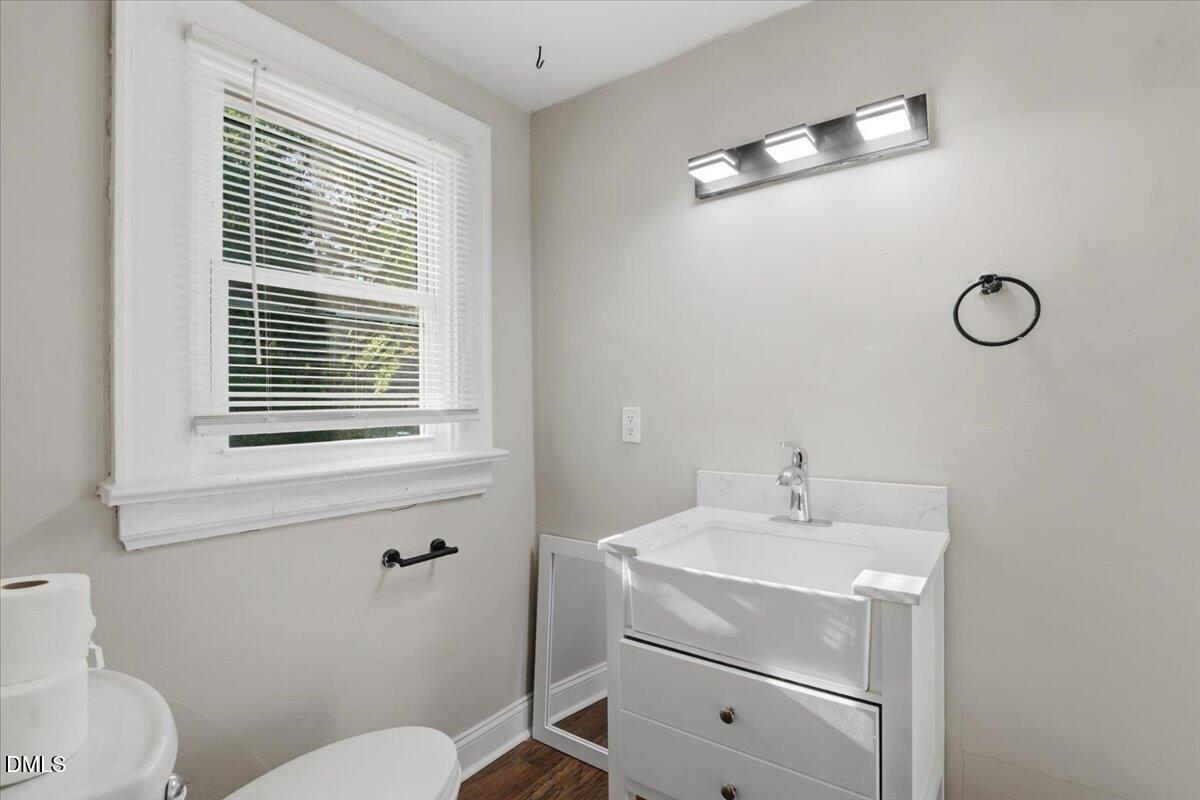 511 South Pine Street Spring Hope, NC 27882 - Photo 17 of 32 a bathroom with a sink mirror vanity and toilet