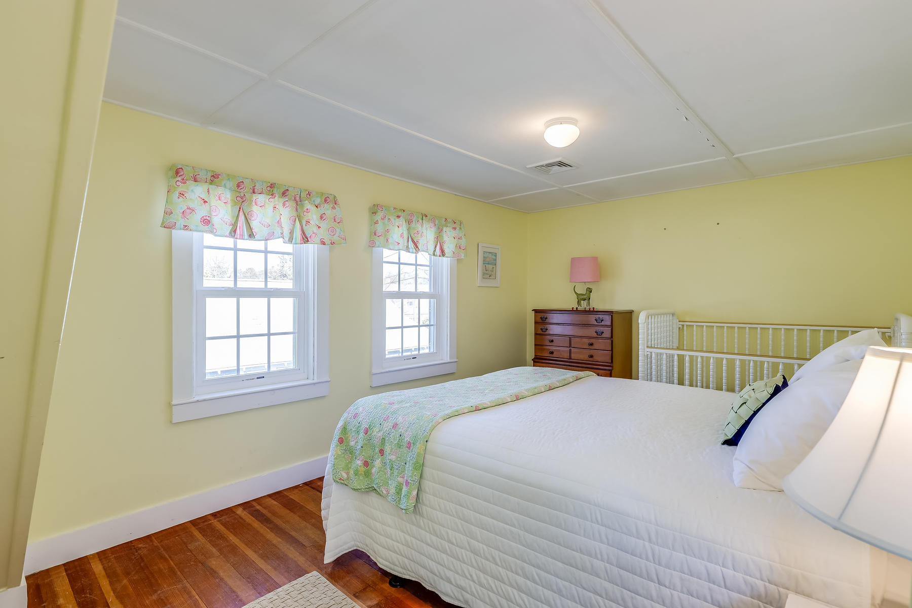 21 Carr Road Dennis Port, MA 02639 - Photo 21 of 33 a bedroom with a bed and wooden floor
