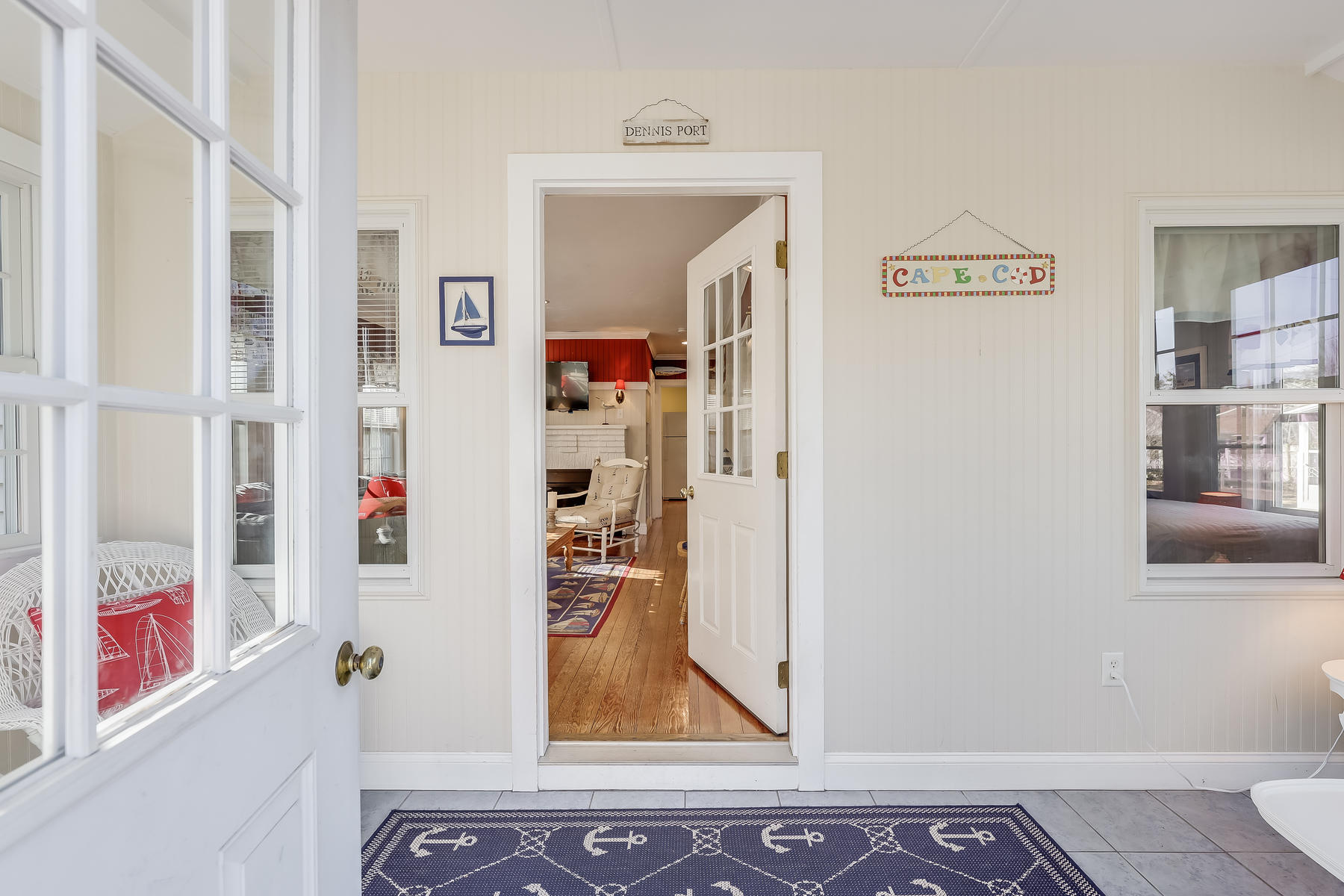 21 Carr Road Dennis Port, MA 02639 - Photo 3 of 33 a view of a hallway with paintings on the wall