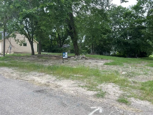 a view of a fire pit with large trees