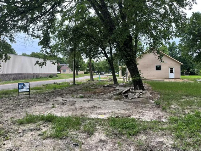 a view of a house with a yard and sitting area