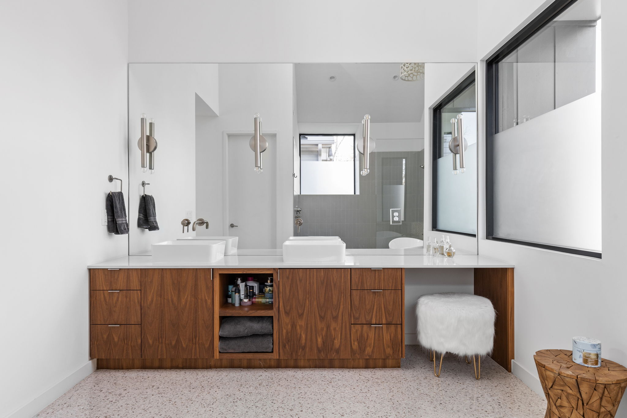 7502 St Louis Street Austin, TX 78757 - Photo 14 of 38 Full bath featuring double vanity and dark aggregate flooring
