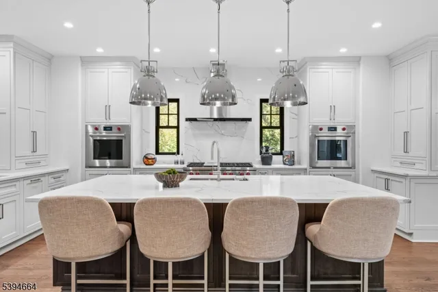 a kitchen with kitchen island a sink stove and refrigerator