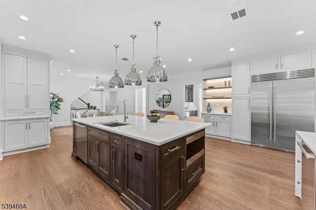 a large kitchen with kitchen island a sink counter space and stainless steel appliances