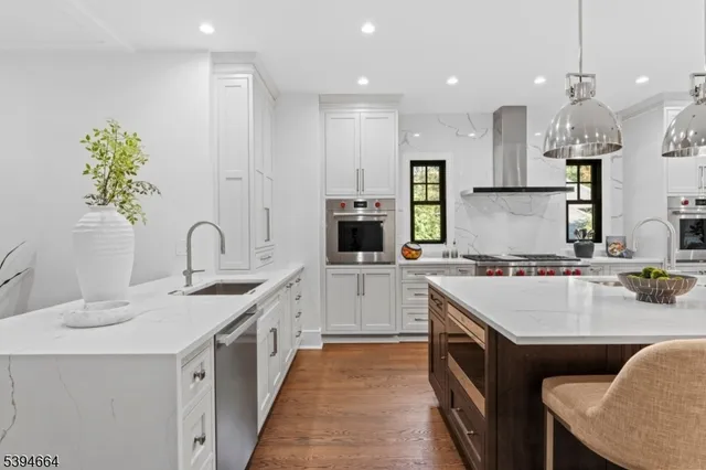 a kitchen with a sink stainless steel appliances and cabinets